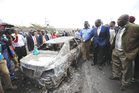 NAIROBI: Kenyan Vice President William Ruto (2nd-R) visits the crash site of a truck that rammed into several vehicles before bursting into flames near Karai on the busy Naivasha highway. — AFP