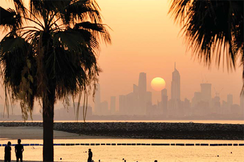 KUWAIT: The sun sets behind the Kuwait City skyline. — KUNA