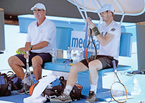 MELBOURNE: Andy Murray of Britain (R) talks with coach Ivan Lendl during a break in his tennis training session at the Rod Laver Arena in Melbourne yesterday. Top players from around the world are arriving in Melbourne in the lead up to the Australian Open from January 16 to 29. – AFP