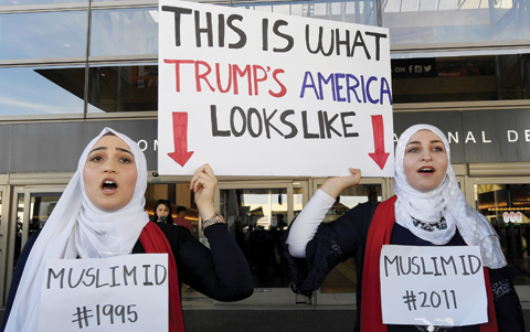 LOS ANGELES: Noor Hindi (left) and Sham Najjar who were born in the US of Syrian parents, demonstrate against the immigration ban imposed by US President Trump at the Los Angeles International Airport, California. — AFP