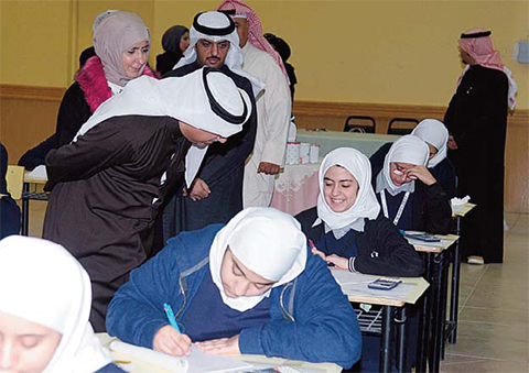 KUWAIT: Education Minister Mohammed Al-Fares tours high schools to check on students taking their midterms yesterday. —KUNA photos