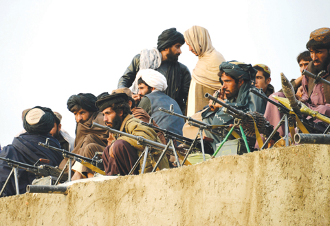 AFGHANISTAN: This file photo shows Afghan Taleban fighters as they listen to an unseen Mullah Mohammad Rasool Akhund, the newly appointed leader of a breakaway faction of the Taliban, at Bakwah in the western province of Farah. —AFP