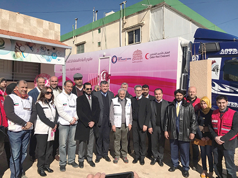 MAJDAL ANJAR: Kuwait Red Crescent Society and Qatar Red Crescent Society officials pose outside a clinic for treating breast cancer cases in east Lebanon. - KUNA