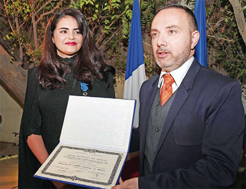 KUWAIT: Kuwaiti researcher Al-Anoud Al-Sharekh with French Ambassador to Kuwait Christian Nakhlah during her honoring ceremony. — KUNA