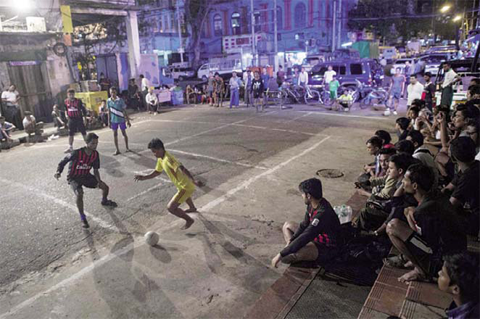 YANGON: This photo is taken on Febuary 9, 2017 shows youth playing football on the street in downtown Yangon.