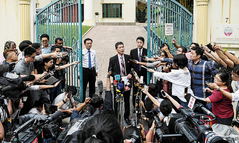 KUALA LUMPUR: Former North Korean deputy ambassador to the United Nations, Ri Tong Il, centre, addresses journalists outside the North Korean embassy in Kuala Lumpur yesterday. —AFP