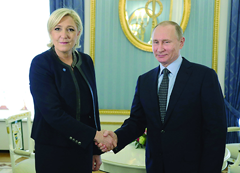 Russian President Vladimir Putin, right, shakes hands with French far-right presidential candidate Marine Le Pen, in the Kremlin in Moscow, Russia, Friday, March 24, 2017. Le Pen has made multiple visits to Russia, as have her father, niece and other members of the National Front, often meeting with Russian legislators. (Mikhail Klimentyev, Sputnik, Kremlin Pool Photo via AP)