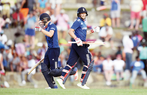 ST JOHN’S: England’s cricketer Chris Woakes (L) and Joe Root celebrate their victory during the second of the three-match One Day International series between England and West Indies at the Sir Vivian Richards Stadium in St John’s, Antigua, on Sunday. — AFP