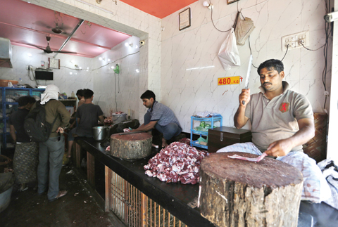 UTTAR PRADESH: An Indian man chops meat at a meat shop in Varanasi, Uttar Pradesh state, India. Uttar Pradesh, India’s most populous state is running out of meat, with the government cracking down on illegal slaughterhouses and meat shops. — AP