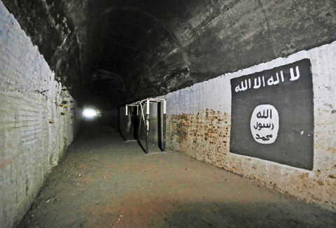 MOSUL: The logo of the Islamic State (IS) group is seen in a tunnel that was reportedly used as a training centre by the jihadists in the village of Abu Sayf, on the southern outskirts of Mosul. — AFP