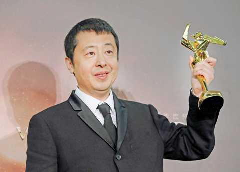 In this file photo, Chinese director Jia Zhangke poses after winning the Best Screenplay award of the Asian Film Awards in Macau. — AP photos