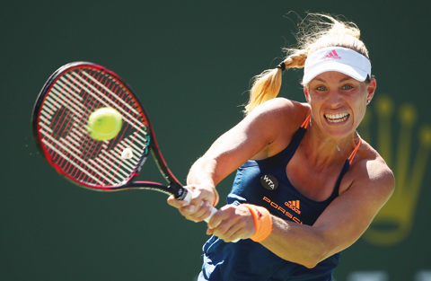 INDIAN WELLS: Angelique Kerber of Germany plays a backhand against Pauline Parmentier of France in their third round match during day eight of the BNP Paribas Open at Indian Wells Tennis Garden on Monday in Indian Wells, California. – AFP