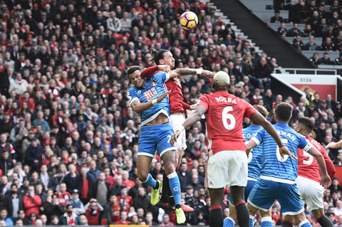 Manchester United's Swedish striker Zlatan Ibrahimovic (2L) clashes in the air with Bournemouth's English defender Tyrone Mings (L) during the English Premier League football match between Manchester United and Bournemouth at Old Trafford in Manchester