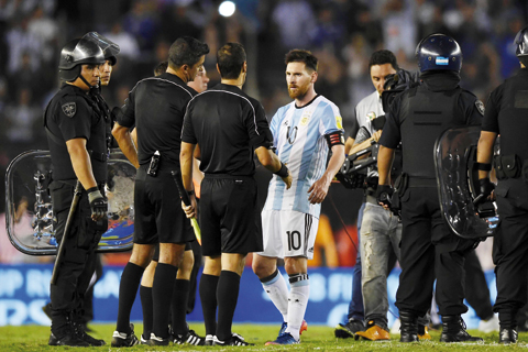 BUENOS AIRES: Argentina's forward Lionel Messi (2nd-R) argues with second assistant referee Marcelo Vangasse (2nd-L) next to Brazilian referee Sandro Ricci (L) and first assistant referee Emerson Augusto de Carvalho (R) in the half time of their 2018 FIFA World Cup Russia South American qualifier football match against Chile, at the Monumental stadium in Buenos Aires, on March 23. FIFA yesterday suspended Messi for four Argentina games. -- AFP nn