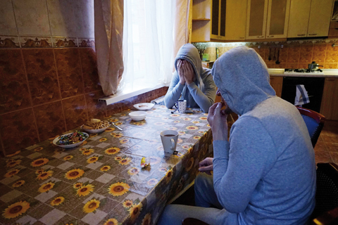MOSCOW: Chechen gay men who fled persecution in their home Russia’s Muslim region of Chechnya due to his sexual-orientation, sits around a table in their flat in Moscow.—AFP