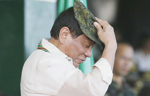TAGUIG CITY: Philippine President Rodrigo Duterte dons a Philippine Army ball cap presented to him by Army Chief Lt Gen Glorioso Miranda during the 120th anniversary celebration of the Philippine Army at Fort Bonifacio in suburban Taguig city, east of Manila, Philippines. - AP 