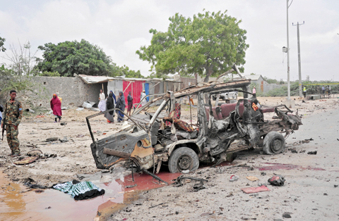 MOGADISHU: A soldier stand guard the street after a suicide car attack near the Defense Ministry. - AFP  