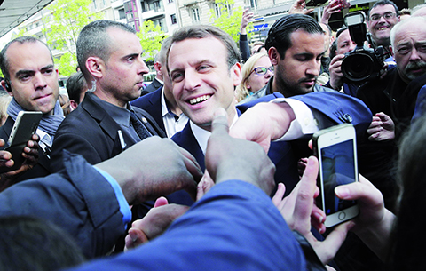 French independent centrist presidential candidate Emmanuel Macron shakes hands to supporters as he campaigns in Rodez, southern France, Friday, May 5, 2017. The 39-year-old independent candidate faces far-right National Front leader Marine Le Pen in Sunday's presidential runoff. (AP Photo/Christophe Ena)