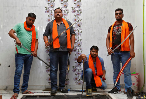 Hindu Yuva Vahini members pose inside the vigilante group’s office in the city of Unnao, India, on April 5, 2017. Photo: Reuters/File
