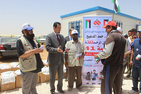 AMMAN: Kuwait's Rahma International charity distributes relief aid and supplies to over 400 Syrian refugee families in Jordan yesterday. - KUNAn