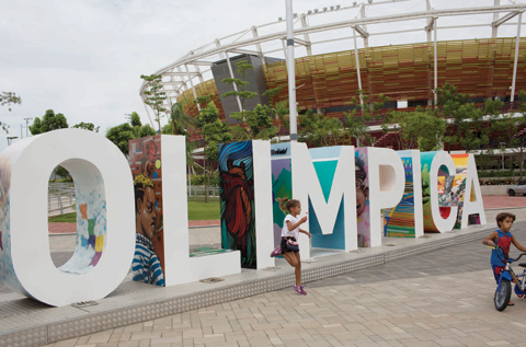   RIO DE JANEIRO: Children play near the Olympic Park sign in Rio de Janeiro, Brazil. _ AP  