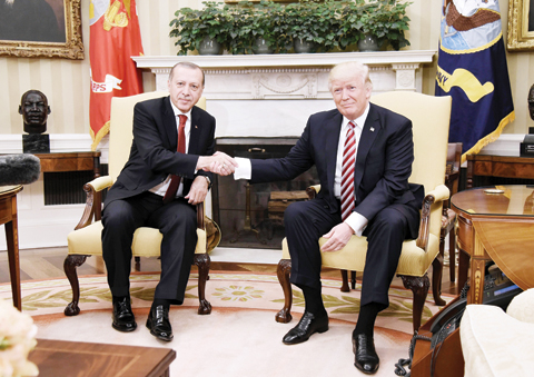 WASHINGTON: US President Donald Trump shakes hands with Turkish President Recep Tayyip Erdogan during a meeting in the Oval Office of the White House yesterday. Talks were expected to focus on ways to mend ties frayed over Syria and the presence in the US of Erdogan foe Fethullah Gulen. – AFP 