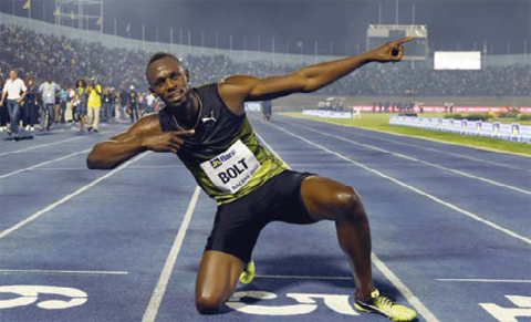 KINGSTON: Usain Bolt (C) of Jamaica reacts after winning his final race in home country during the Racers Grand Prix at the national stadium in Kingston, Jamaica, on Saturday. Bolt partied with his devoted fans in an emotional farewell at the National Stadium on June 10 as he ran his final race on Jamaican soil. Bolt is retiring in August following the London World Championships. — AFP