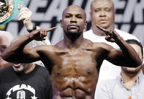 LAS VEGAS: In this Sept. 12, 2014, file photo, Floyd Mayweather Jr. poses on the scale during a weigh in for a fight against Marcos Maidana in Las Vegas. Mayweather Jr. said Wednesday, he will come out of retirement to face UFC star Conor McGregor in a boxing match on Aug. 26. — AP