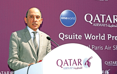 LE BOURGET: Chief Executive Officer of Qatar Airways Akbar Al Baker speaks in front of a Qatar Airways Boeing 777, as part of the presentation for the new Qsuite business class seating yesterday at Le Bourget airport, near Paris, on the opening day of the International Paris Air Show. — AFP