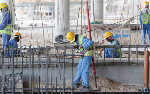 DOHA: This file photo shows migrant laborers working on a construction site in Doha in Qatar.—AFP