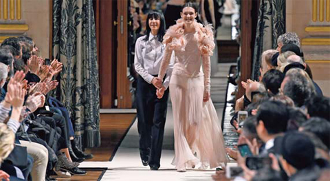 This file photo shows French fashion designer for Lanvin, Bouchra Jarrar, left, acknowledging the audience at the end of her women's Fall-Winter 2017- 2018 ready-to-wear collection fashion show in Paris.