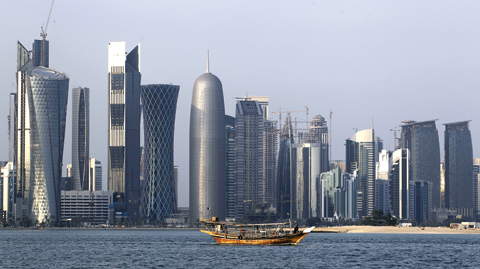DOHA: In this Thursday Jan 6, 2011 file photo, a traditional dhow floats in the Corniche Bay of Doha, Qatar, with tall buildings of the financial district in the background. — AP