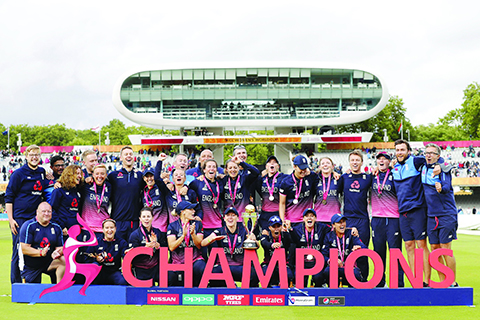 LONDON: England players pose with the trophy after winning the ICC Women's World Cup cricket final between England and India at Lord's cricket ground in London yesterday. – AFP
