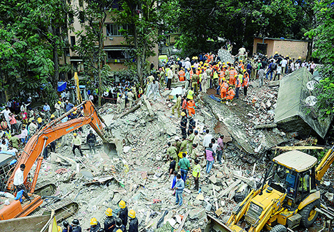 MUMBAI: Indian rescue workers look for survivors in debris at the sitenof a building collapse. - AFP 
