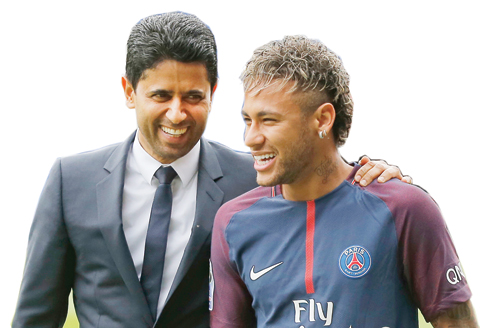 Brazilian soccer star Neymar walks away with the chairman of Paris Saint-Germain Nasser Al-Khelaifi, left, following a press conference in Paris Friday. — AP