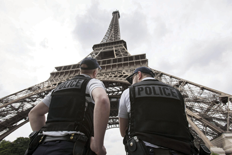 PARIS: In this Friday, June 10, 2016 file photo, French riot police officers patrol under the Eiffel Tower. —AP