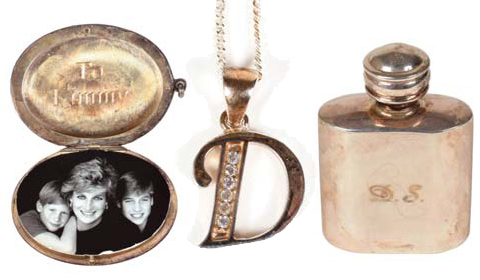 A locket containing a photograph of Princess Diana and her sons Prince Harry, left, and Prince William, sterling silver perfume bottle, engraved on the front with Princess Diana’s pre-marriage initials “D.S.” (Diana Spencer) and a charm in the shape of her first initial D, thought to have been worn as a teen by Princess Diana.