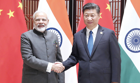 XIAMEN: In this photo released by China’s Xinhua News Agency, Indian Prime Minister Narendra Modi, left, and China’s President Xi Jinping shake hands as they pose for a photo during a meeting on the sidelines of the BRICS Summit in Xiamen in southeastern China’s Fujian Province. — AP