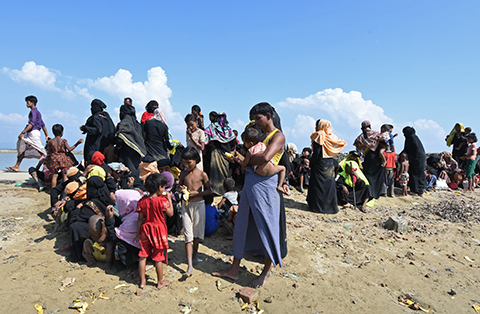 TEKNAF, Bangladesh: Rohingya refugees rest after crossing into Bangladesh from Myanmar at Shah Porir Dwip Island near Teknaf yesterday. - AFP 