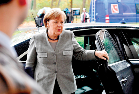 BERLIN: German Chancellor and leader of the Christian Democratic Union (CDU) party Angela Merkel arrives at the representative office for further exploratory talks with members of potential coalition parties. — AFP