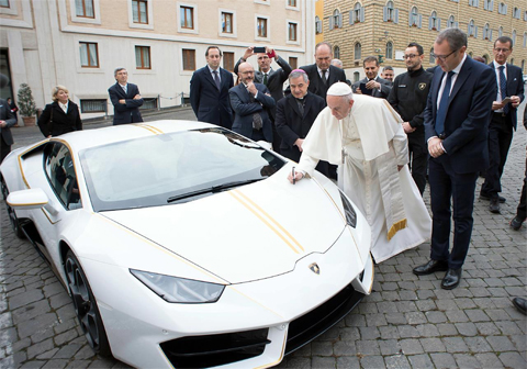 The blessing of the sports car. Photo: Osservatore Romano/AFP