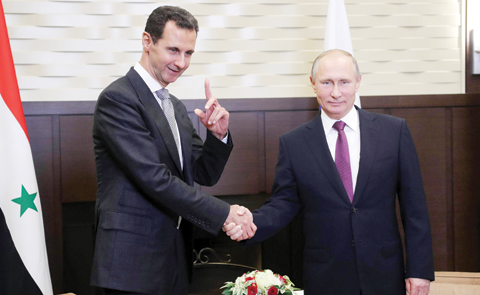 nSOCHI: Russia's President Vladimir Putin (right) shakes hands with his Syrian counterpart Bashar Al-Assad during a meeting on Monday. - AFP nn