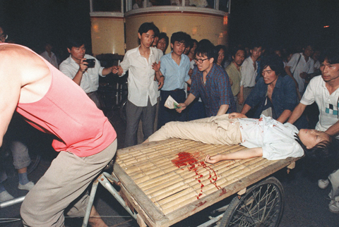 BEIJING: File photo taken on June 4, 1989 shows a girl wounded during a clash between the army and students near Tiananmen Square in Beijing.—AFP