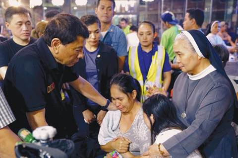 DAVAO CITY: Philippines’ President Rodrigo Duterte comforting a relative of one of the victims after a fire engulfed a shopping mall in Davao City on the southern Philippine island of Mindanao. —AFP