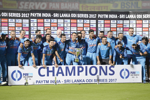 VISAKHAPATNAM: Indian cricket team pose as they hold the One Day series cup after winning the third One Day International (ODI) cricket match between India and Sri Lanka at the Dr. Y.S. Rajasekhara ReddynACA-VDCA Cricket Stadium in Visakhapatnam yesterday. – AFPnn