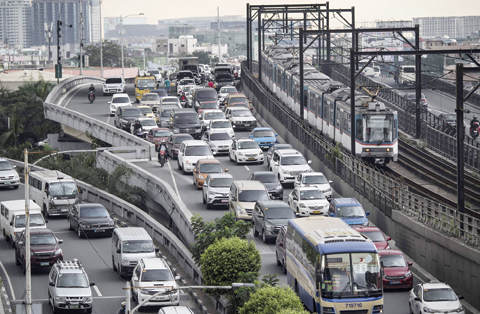 MANILA: This general shot shows vehicles stuck in traffic in Manila.—AFP