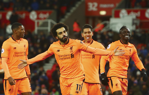 STOKE-ON-TRENT: File photo shows Liverpool’s Egyptian midfielder Mohamed Salah (C) celebrates scoring their second goal during the English Premier League football match between Stoke City and Liverpool. — AFP