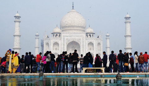 Crowds gather to visit the Taj Mahal in Agra yesterday. — AFP photos