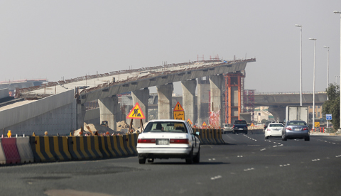 KUWAIT: Vehicles drive by an overpass under construction in Kuwait. — Photo by Yasser Al-Zayyat