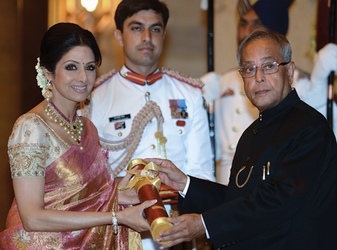 This file photo taken on April 5, 2013 shows then-Indian President Pranab Mukherjee (R) presenting the Padma Shree award to Indian film actress Sridevi (L) during the presentation of the “Padma Awards 2013” at the Presidential Palace in New Delhi.